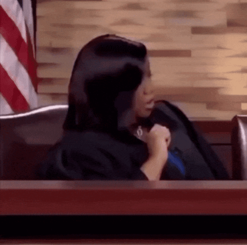 Woman in Black Gown Sitting in Courtroom