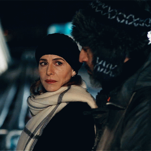 Woman In Black Hat And Scarf Next To Man GIF
