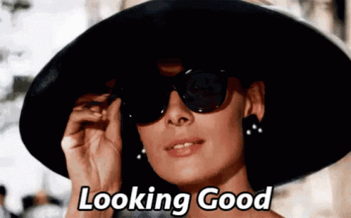 Woman in Black Hat and Sunglasses Says Looking Good