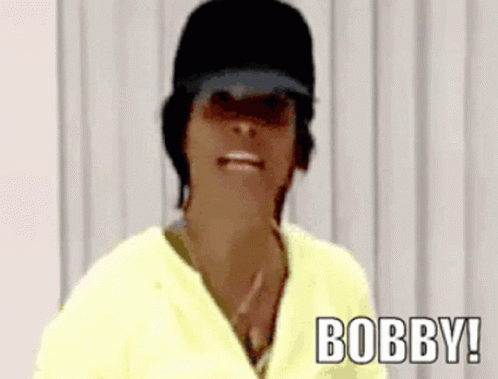 Woman in Black Hat and Yellow Shirt Saying Bobby