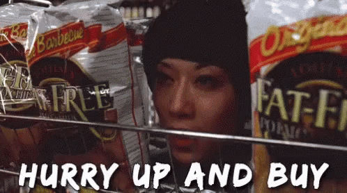 Woman In Black Hat Looking At Fat-Free Chips GIF
