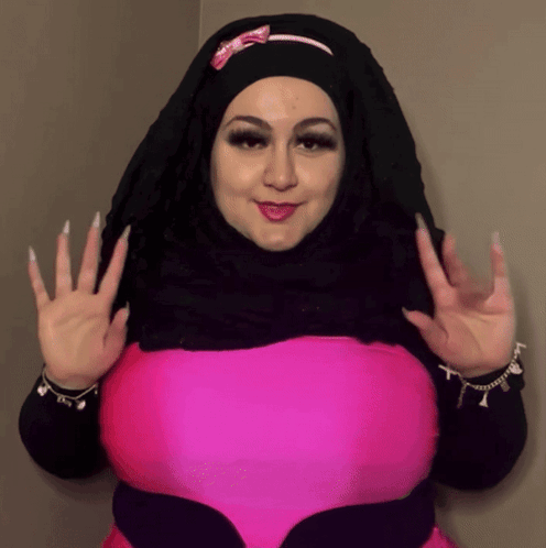 Woman in Black Hijab and Pink Top Waving