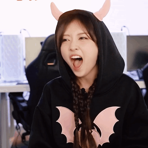 Woman In Black Hoodie With Bat GIF