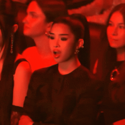 Woman in Black Jacket and Earrings in Dark Room