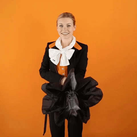 Woman in Black Jacket and White Bow Tie Holding Black Umbrella