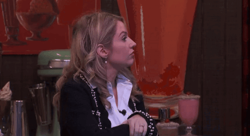 Woman In Black Jacket And White Shirt Looking Up GIF