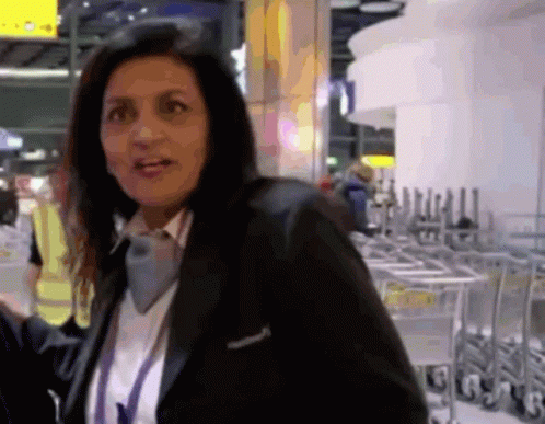 Woman in Black Jacket at Carts Marked G