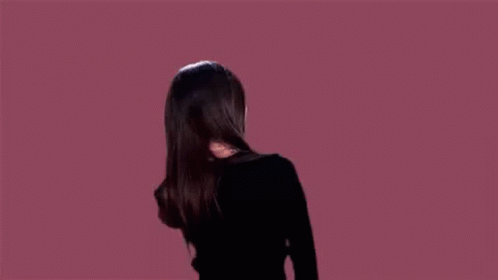 Woman in Black Jacket Dancing With Wind-Blown Hair