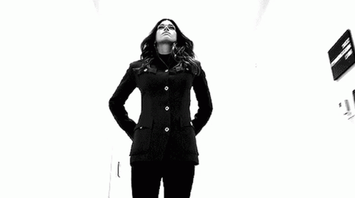 Woman in Black Jacket Holding Two Sticks