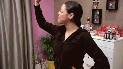 Woman in Black Jacket in Front of Pink Wall