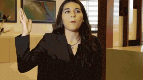 Woman In Black Jacket Raising Hand GIF