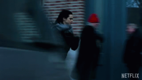 Woman in Black Jacket Running Past Blue Door Netflix