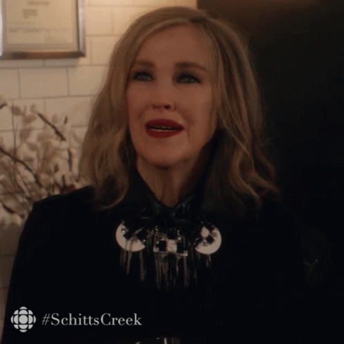 Woman In Black Jacket With Schitts Creek Hashtag GIF