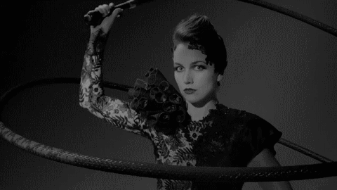 Woman In Black Lace Dress Holding Whip GIF