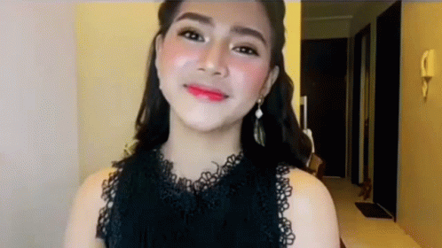 Woman in Black Lace Top and Earrings Smiling