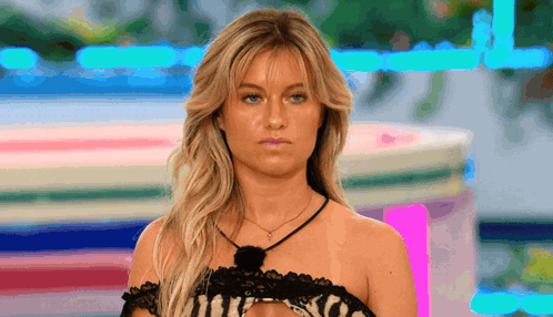 Woman In Black Lace Top Looking At Camera GIF