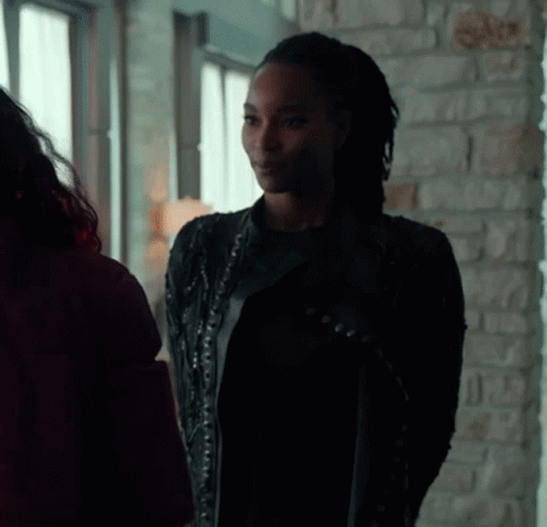 Woman In Black Leather Jacket Next To Woman In Red Jacket GIF