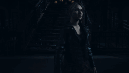 Woman In Black Leather Jacket Standing In Dark GIF