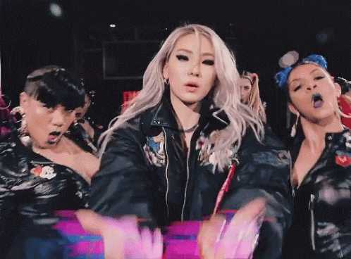 Woman In Black Leather Jacket Surrounded By Women GIF
