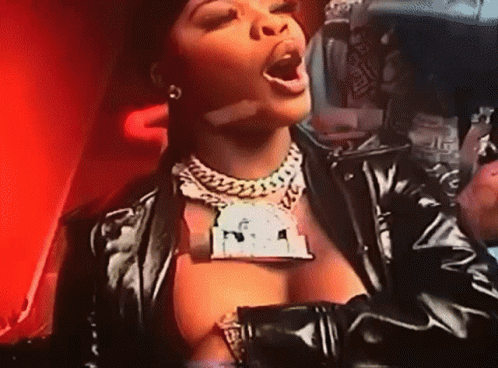 Woman in Black Leather Jacket with Dollar Sign Necklace