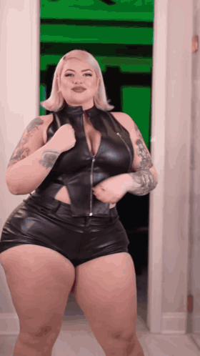 Woman in Black Leather Outfit Standing in Doorway
