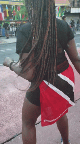 Woman in Black Shirt and Red Shorts Saying Trinidad and Tobago
