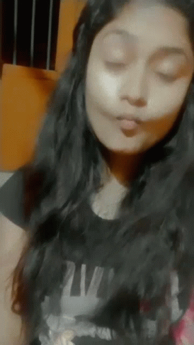 Woman in Black Shirt Saying NM