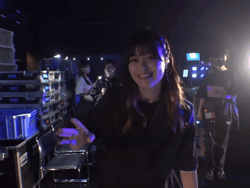 Woman In Black Shirt Smiling And Waving GIF