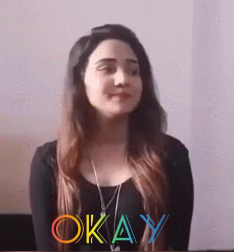 Woman in Black Shirt Standing Before Okay Sign