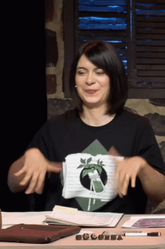 Woman in Black Shirt With Plant Sitting at Desk