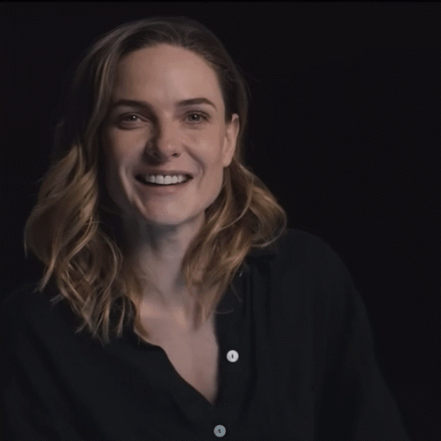 Woman in Black Shirt With White Buttons Smiling