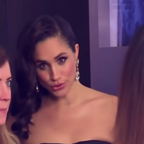 Woman in Black Strapless Dress and Earrings Posing
