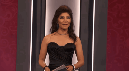 Woman in Black Strapless Dress Holding Microphone