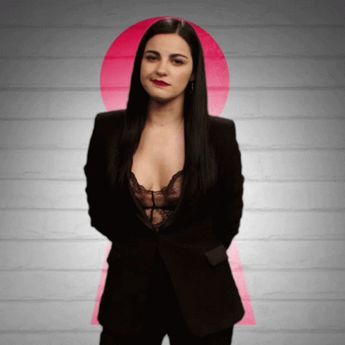 Woman in Black Suit and Lace Bra in Front of Pink Keyhole