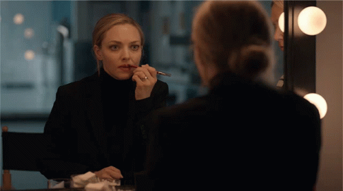 Woman in Black Suit Applying Lipstick