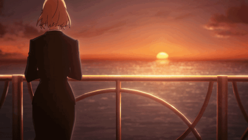 Woman in Black Suit Overlooking Ocean Sunset