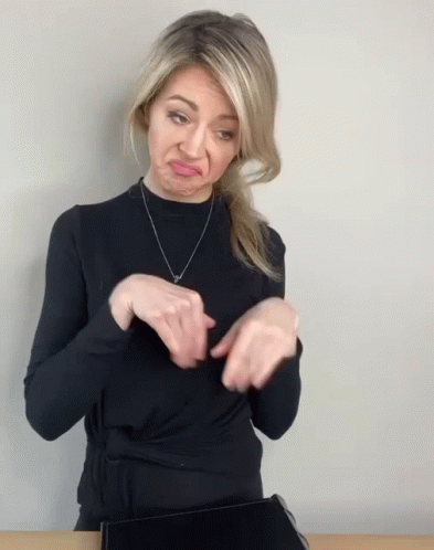 Woman in Black Sweater Making Face With Hands