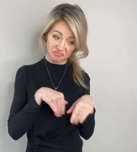 Woman in Black Sweater Making Funny Face With Hands