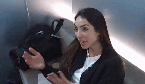 Woman In Black Sweater Sitting On Chair GIF