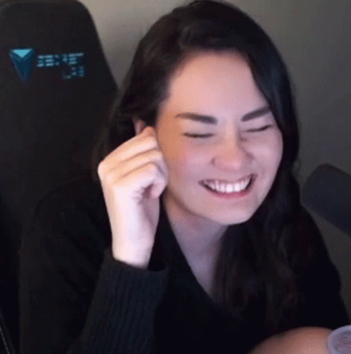 Woman in Black Sweater Smiling With Eyes Closed