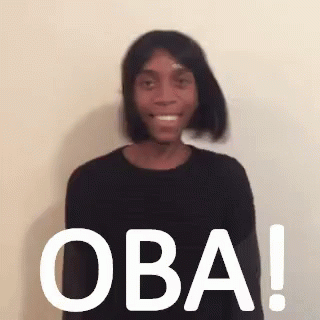 Woman In Black Sweater Wig Smiling Owa Sign GIF