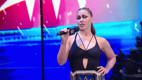 Woman in Black Swimsuit Holding Microphone
