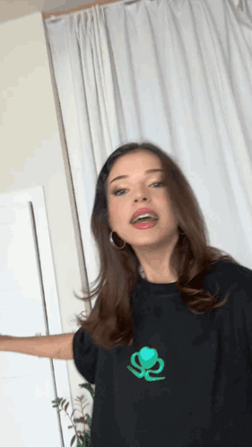 Woman In Black T-Shirt With Green Logo GIF
