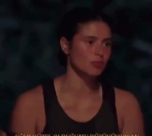 Woman in Black Tank Talking in Dark Room