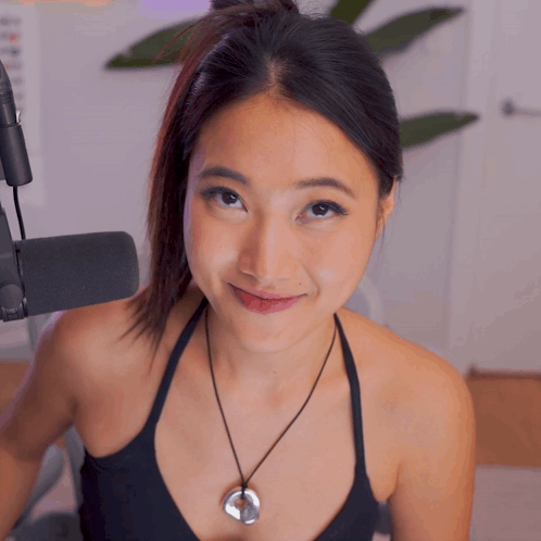 Woman in Black Tank Top and Silver Pendant