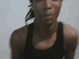 Woman In Black Tank Top Looking At Camera GIF
