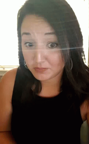 Woman in Black Tank Top Looks Surprised