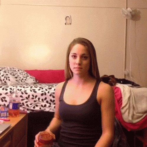 Woman in Black Tank Top Sitting