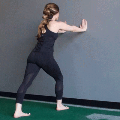 Woman in Black Tank Top Sitting on Gym Floor in Front of Mirror