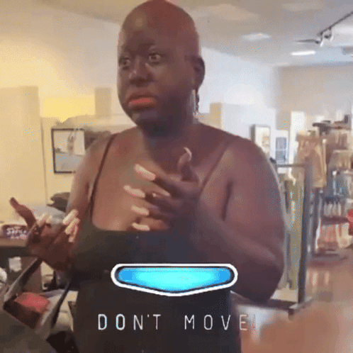 Woman In Black Tank Top Standing By 'Don't Move' Sign GIF